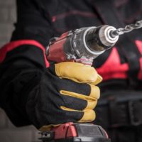worker using a power screw driver in the workplace