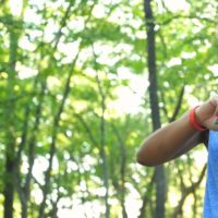 Female jogger using her wearable fitness device