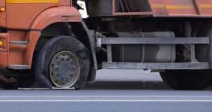 Reading personal injury lawyers discuss how should drivers handle truck accidents caused by tire blowouts.