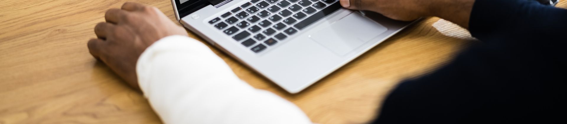 Injured office worker at their laptop