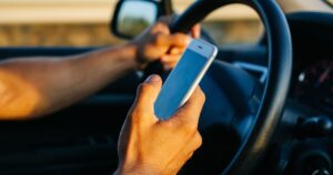 man texting on his cellphone while driving