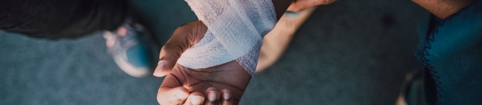 Man getting injured hand wrapped.